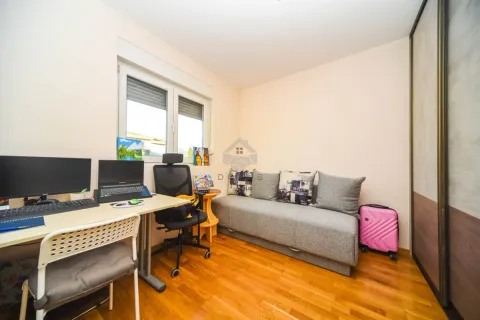 Small bedroom with a sofa bed, desk, and wardrobe. - image 4