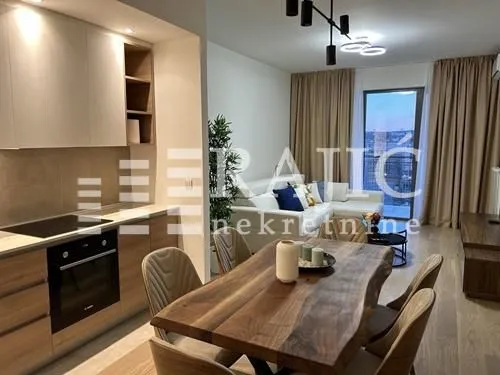 Modern living room connected to the dining area and kitchen.
