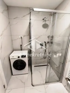 Bathroom with a shower cabin and a washing machine. - image 19