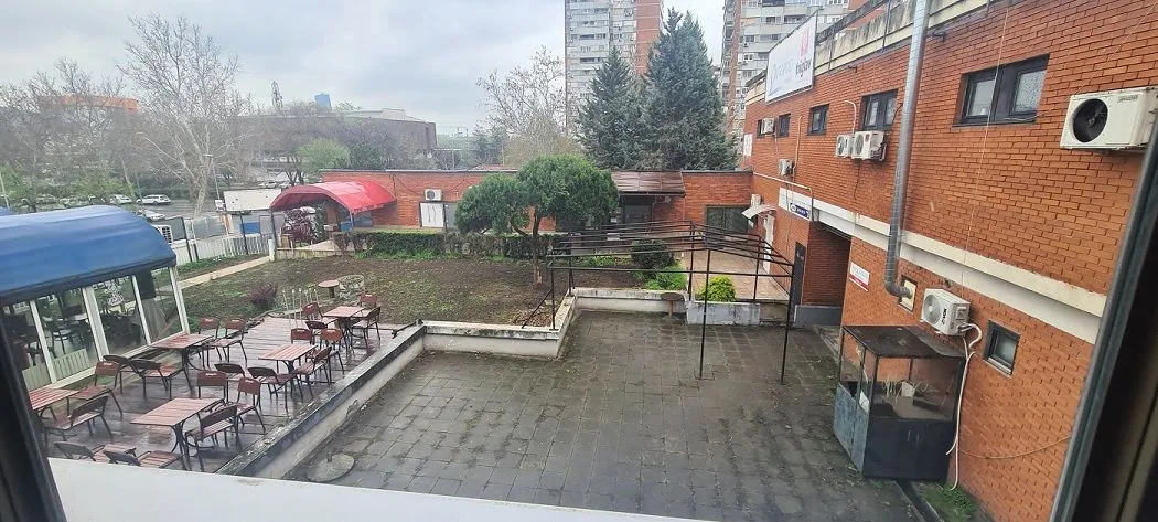 View from the window of the outdoor area and surrounding buildings.