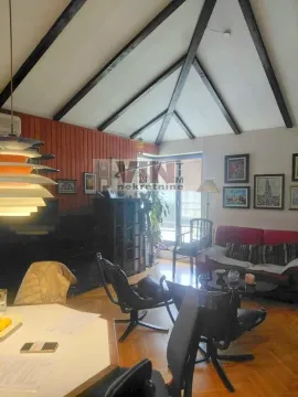 Living room with wooden ceiling beams and furniture. - image 12