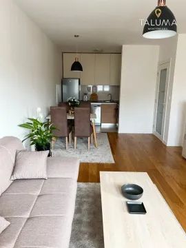 Living room with dining area and kitchen in an open space layout. - image 3