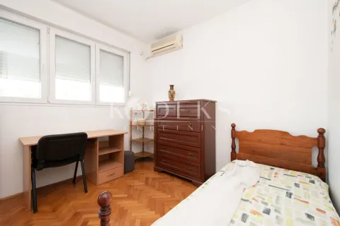 Bedroom with a bed, desk, and wooden chest of drawers. - image 4