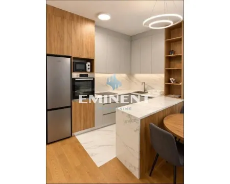 Modern kitchen with built-in appliances and a dining table. - image 4