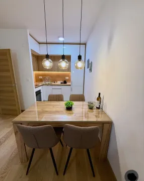 Modern kitchen with dining area and built-in appliances. - image 4