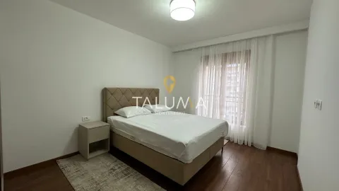 Bedroom with a double bed, nightstand, and a window with curtains. - image 5