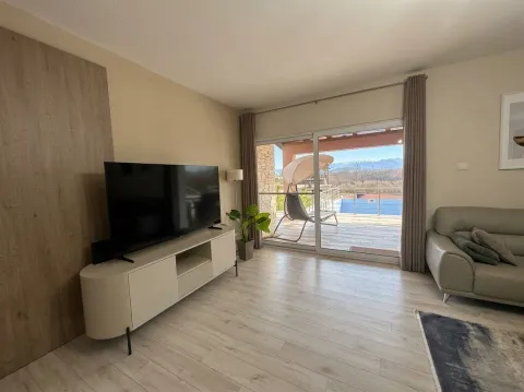 Living room with a TV and access to the terrace with a swimming pool. - image 5