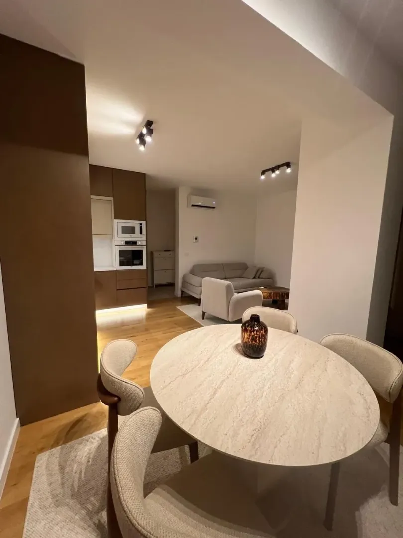 Living room with a dining area and kitchen in the background.