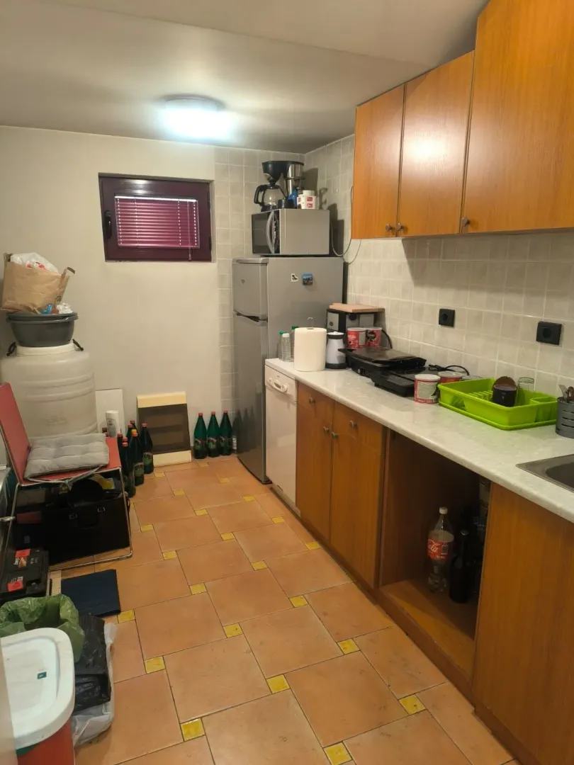 Smaller kitchen with wooden cabinetry and home appliances.