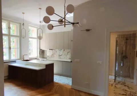 Modern kitchen with an island and dining area within an open space. - image 9