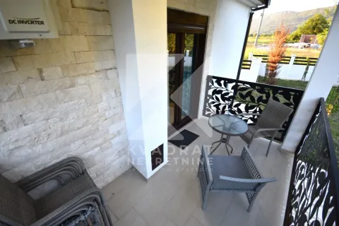 Covered terrace with seating furniture and a view of the yard. - image 24