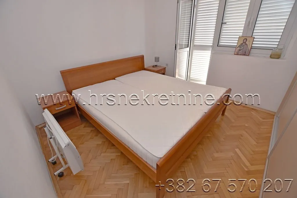 Bedroom with a double bed and parquet flooring.