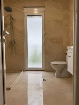 Bright bathroom with shower and toilet. - image 7
