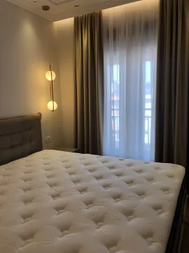 Bright bedroom with a double bed and a modern pendant lamp. - image 8