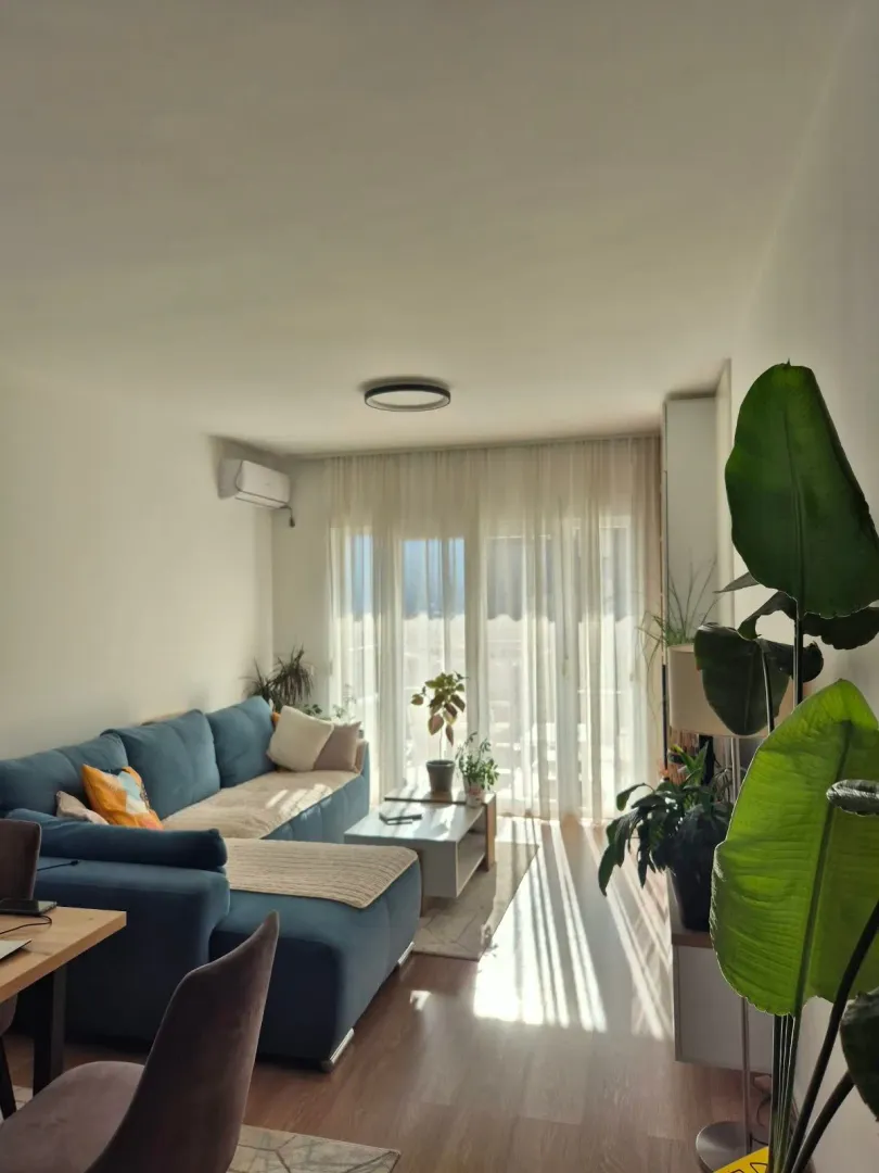 Living room with a sofa and access to the terrace.