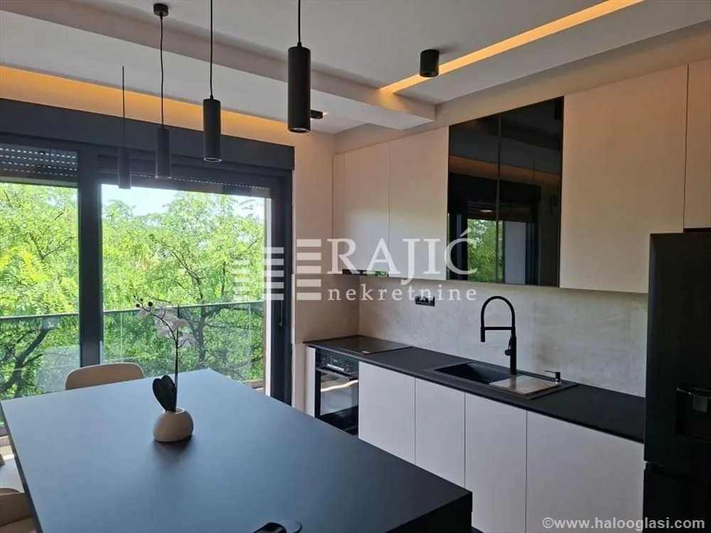 Modern kitchen with an island and built-in appliances.