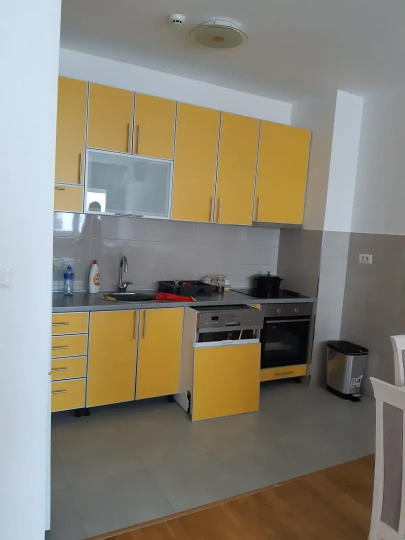 Bright kitchen with yellow cabinets.