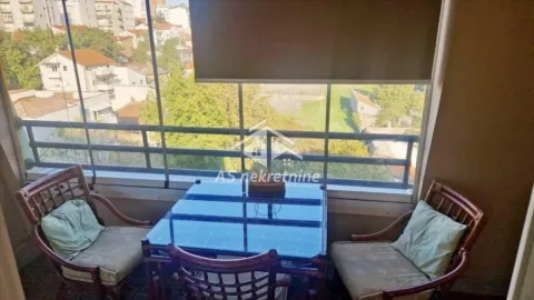 Enclosed balcony with seating furniture and a view of the surroundings. - image 12