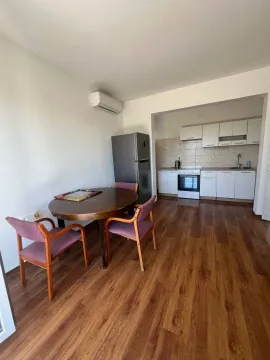 Dining area with table and chairs overlooking the kitchen. - image 3