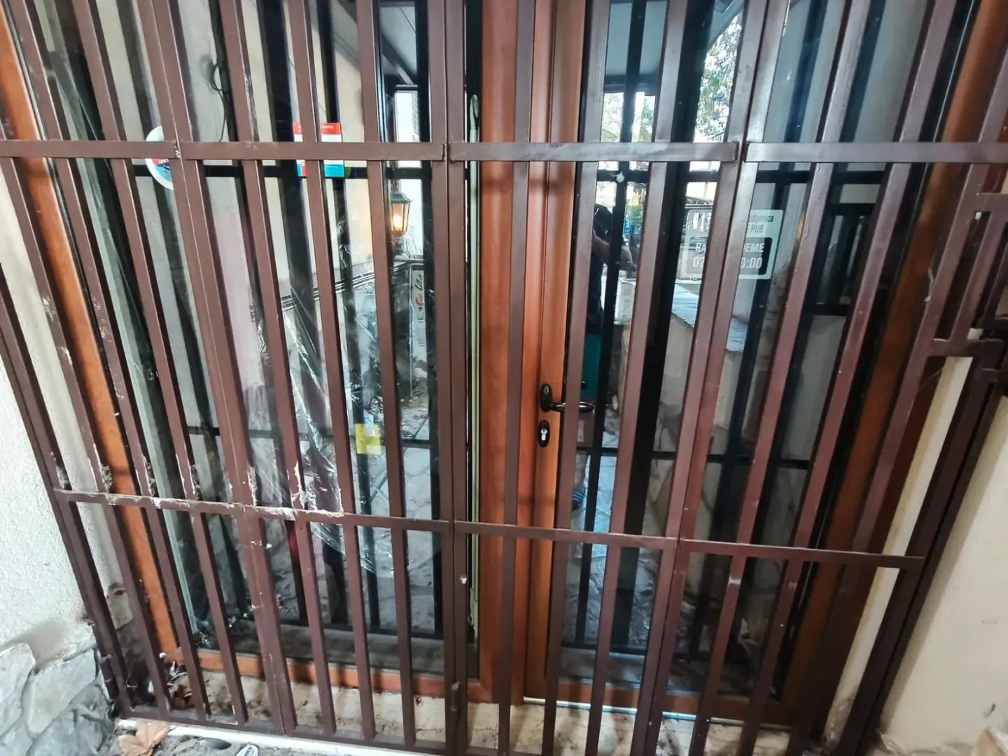 Entrance door with protective metal grilles.