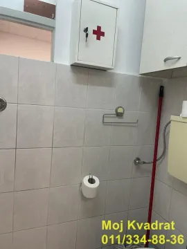 View of the tiled part of the bathroom with sanitary facilities and a cabinet. - image 4