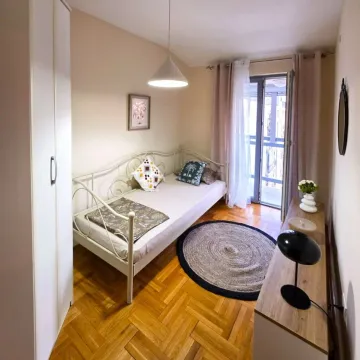 Small bedroom with a bed, wardrobe, and access to the terrace. - image 7
