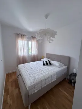 Bright bedroom with a double bed and a window. - image 5