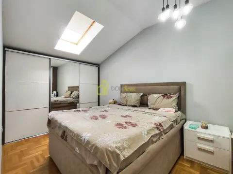 Bedroom with a double bed, large wardrobe, and a skylight. - image 9