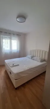 Bright bedroom with a double bed and a window. - image 4