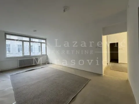 Empty room with a window and white walls. - image 2