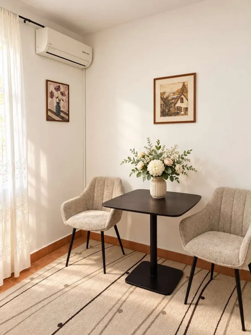 Small table with two armchairs in a bright interior.