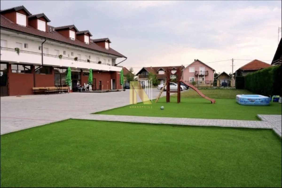 View of the building courtyard with a lawn and a playground.