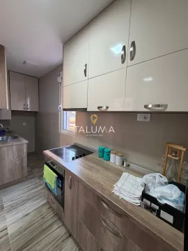 Small kitchen with wooden cabinets, built-in oven and stove. - image 15