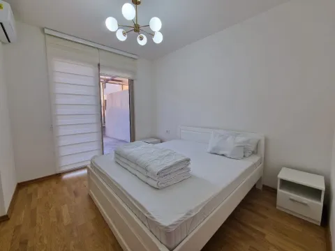 Bedroom with a double bed, bedside table, and access to the terrace. - image 23