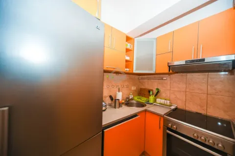 Kitchen with orange cabinets and appliances. - image 31