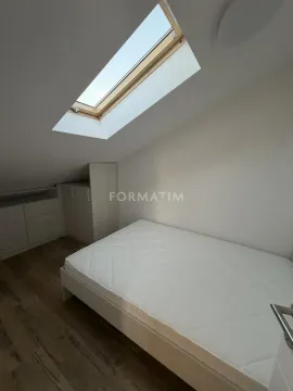Attic bedroom with a bed and fitted wardrobes under the sloping roof. - image 11