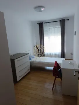 Small bedroom with a bed, dresser, and a desk. - image 10