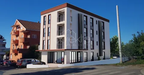 Exterior view of a modern residential building with balconies and parking. - image 2