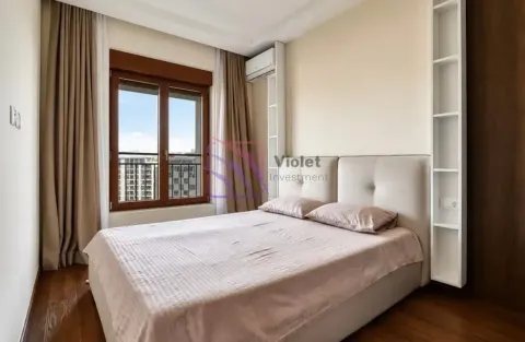 Furnished bedroom with a double bed, window, and built-in shelving. - image 10