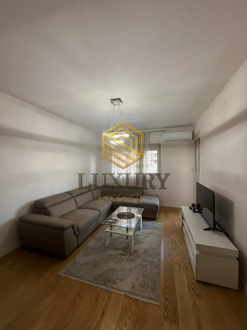 Living room with a sectional sofa, coffee table, and TV.
