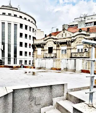 Spacious rooftop terrace overlooking surrounding buildings. - image 2