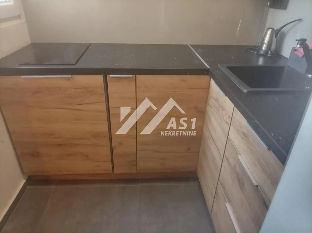 Kitchen cabinets with countertop and sink.