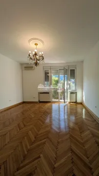 Empty living room with parquet flooring and balcony access. - image 16