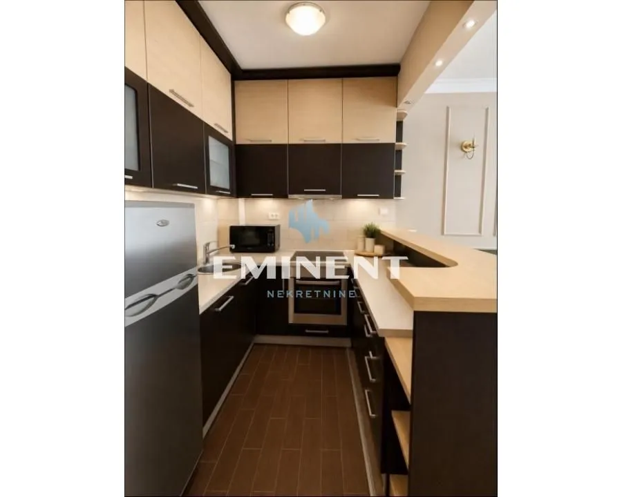 Kitchen equipped with wooden cabinetry and a kitchen bar.