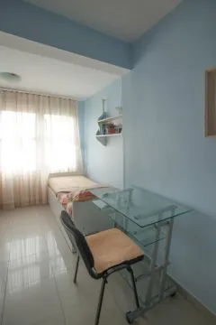 Small bedroom with a bed, desk, and chair. - image 11