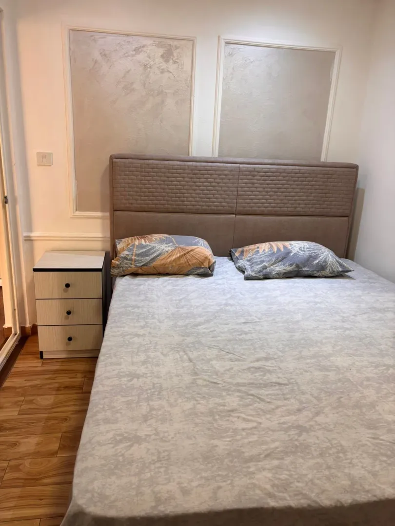 Bedroom with a double bed and a nightstand.