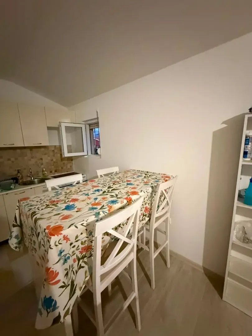 Smaller kitchen with a dining table and white cabinets.