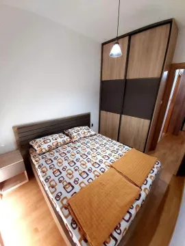 Bedroom with a double bed and a large wardrobe. - image 6