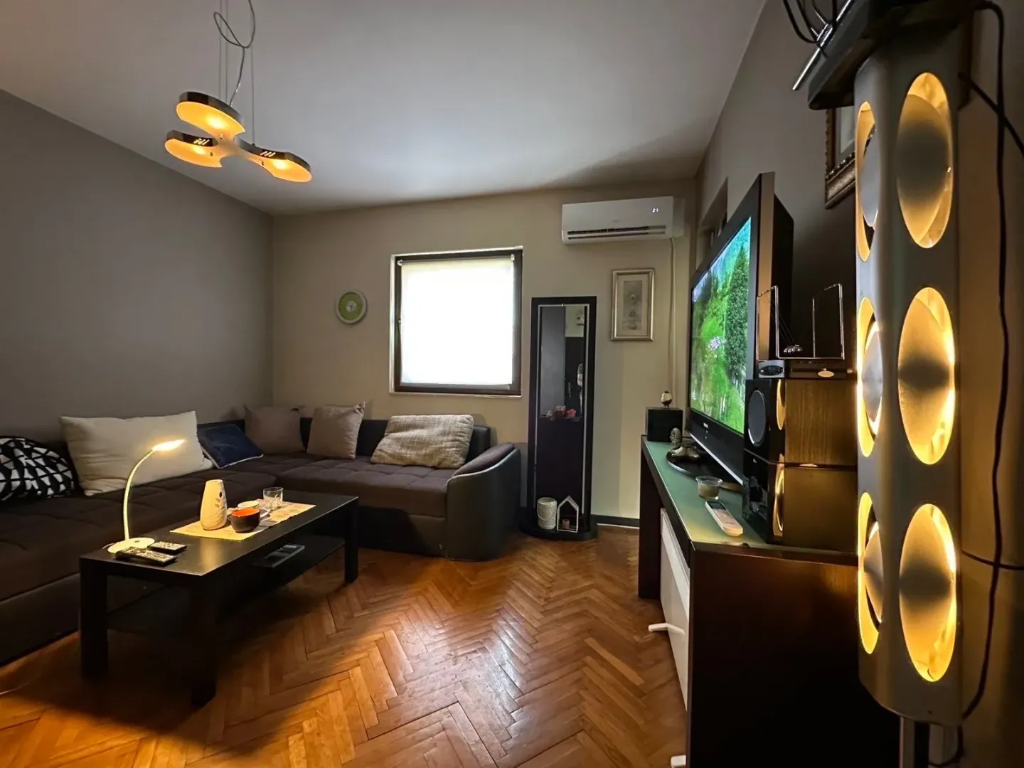 Furnished living room with a sectional sofa and a TV.