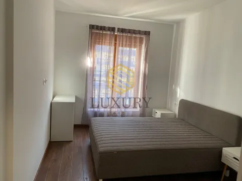 Bright bedroom with a double bed and a window. - image 6